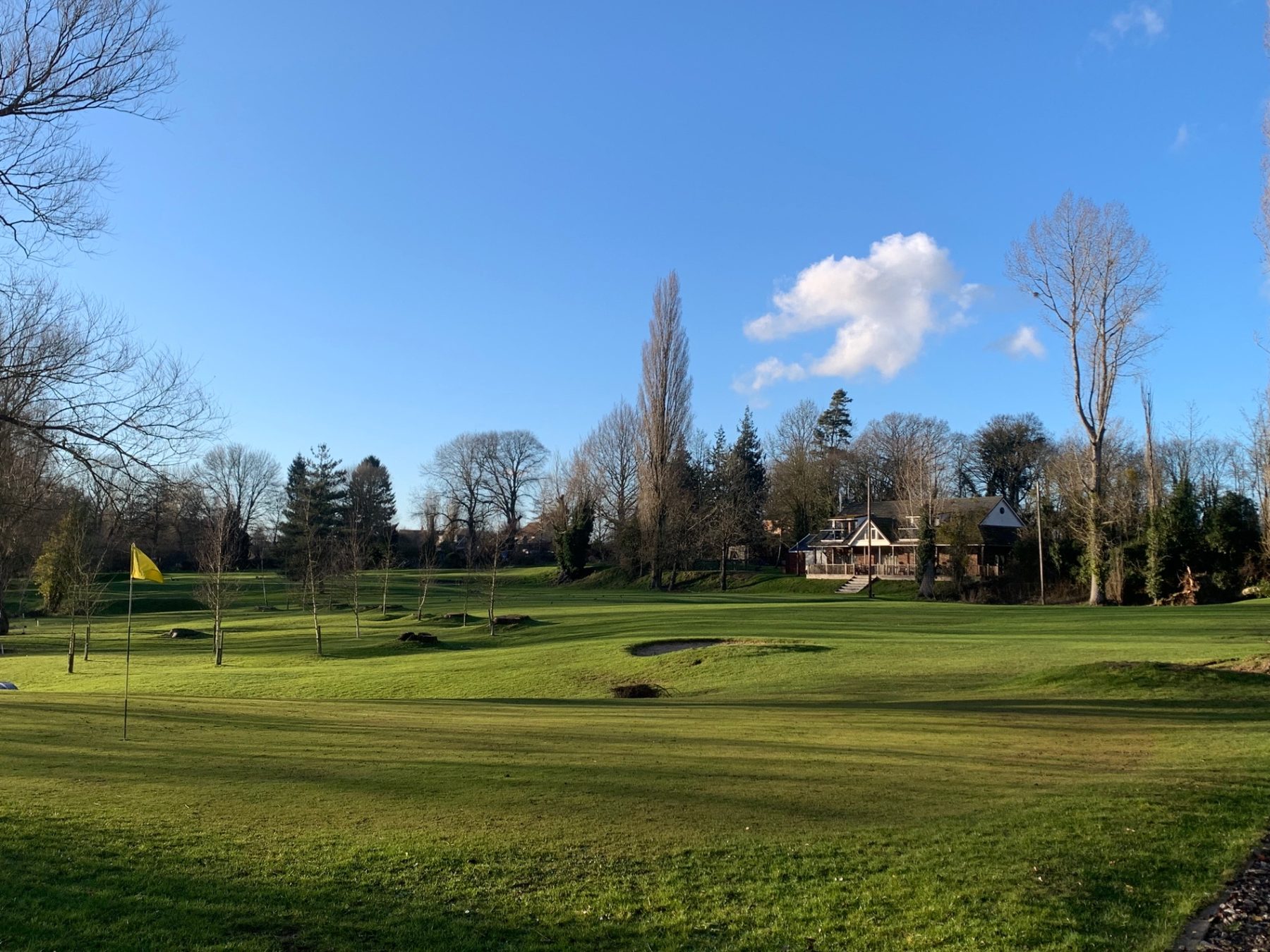 The clubhouse across the fairway on a bright winter day
